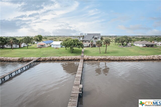 dock area featuring a yard and a water view