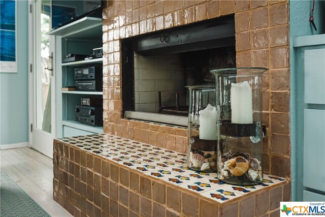 interior details with hardwood / wood-style floors and decorative backsplash