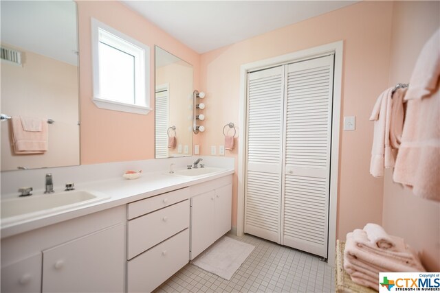 bathroom with tile patterned flooring and vanity