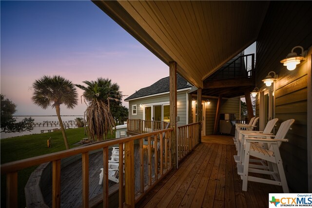 deck at dusk with a lawn