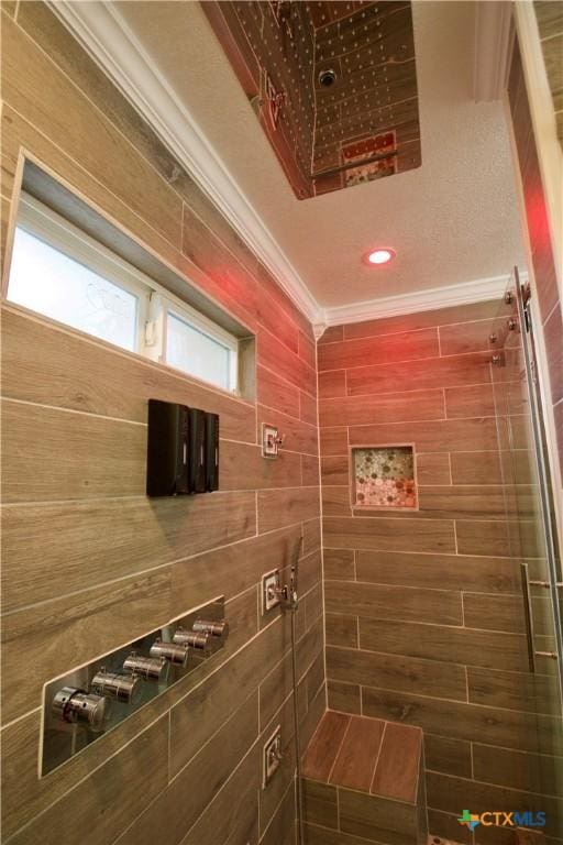 bathroom featuring crown molding and a shower with shower door