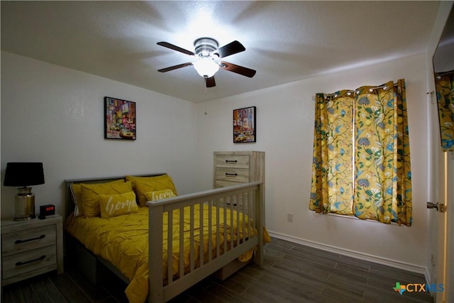 bedroom with dark hardwood / wood-style floors and ceiling fan