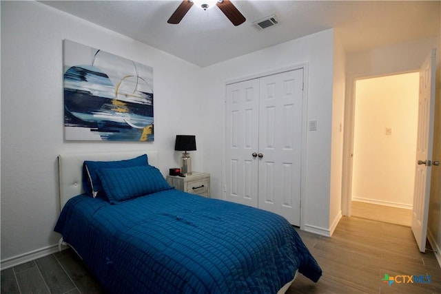 bedroom with ceiling fan and a closet