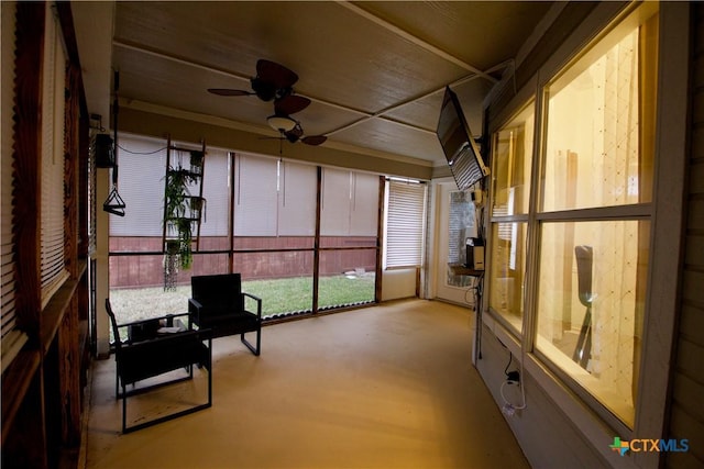 unfurnished sunroom with ceiling fan