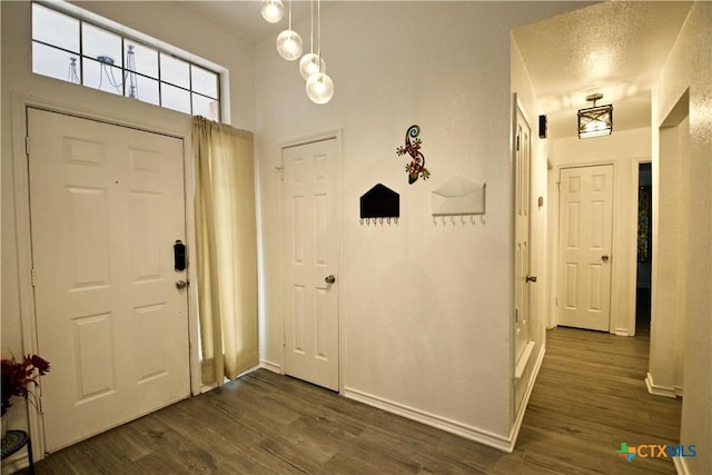 entrance foyer featuring dark wood-type flooring and a textured ceiling