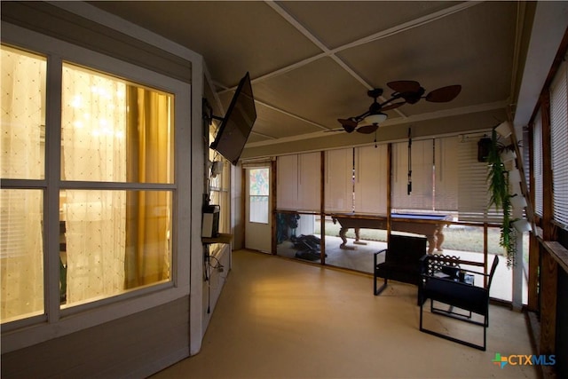 unfurnished sunroom with ceiling fan