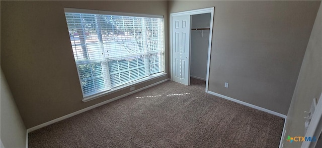 unfurnished bedroom featuring a closet, carpet, and baseboards