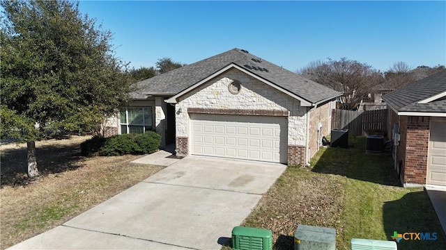 view of front of property featuring a garage, concrete driveway, and brick siding