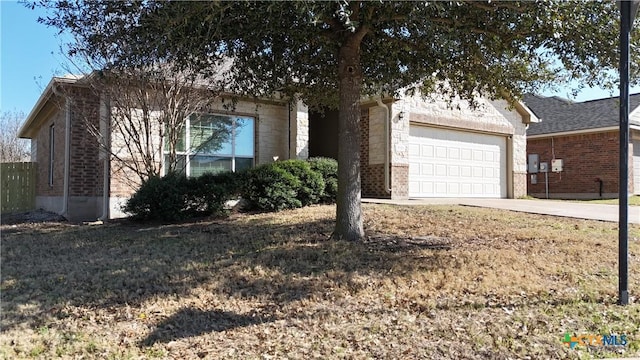 view of front of house featuring a garage, stone siding, driveway, and brick siding