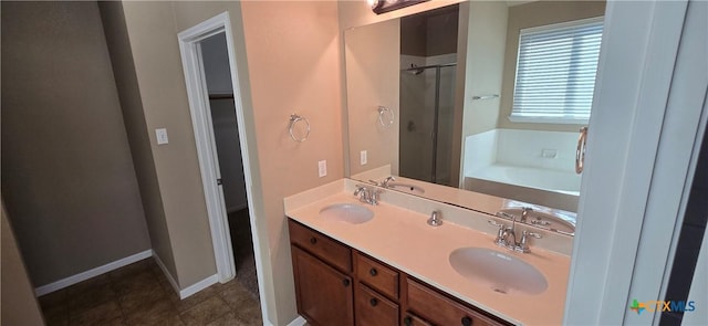 bathroom with a bath, a shower stall, and a sink