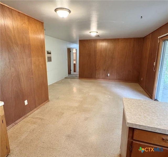 unfurnished room with wood walls