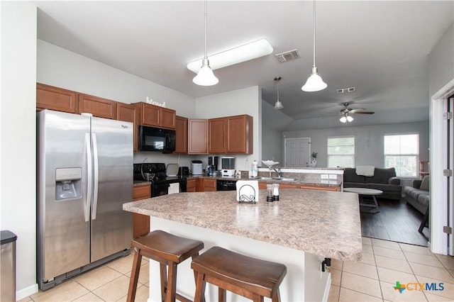 2324 Bellmont, Temple, TX 76504 - kitchen with black appliances, light tile patterned flooring, brown cabinetry, and ceiling fan
