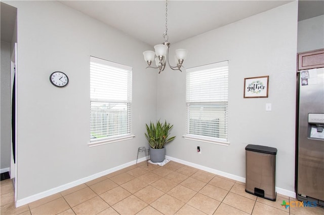 2324 Bellmont, Temple, TX 76504 - unfurnished dining area with a chandelier, light tile patterned flooring, and baseboards