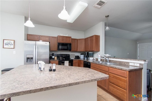 2324 Bellmont, Temple, TX 76504 - kitchen with black appliances, a sink, a peninsula, hanging light fixtures, and a kitchen island