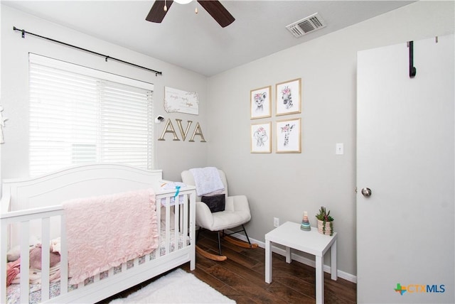 2324 Bellmont, Temple, TX 76504 - bedroom with wood finished floors, a nursery area, baseboards, and a ceiling fan