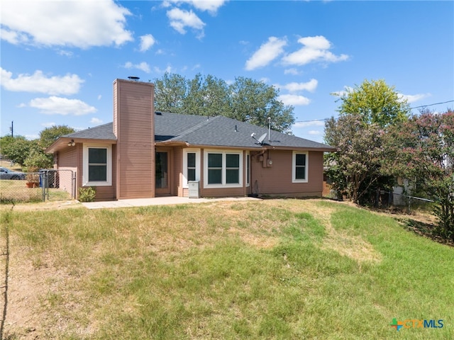 back of property featuring a yard and a patio