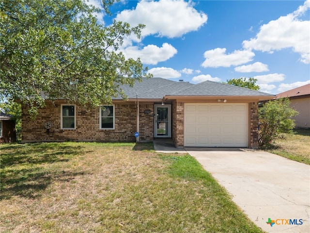 single story home featuring a garage and a front yard