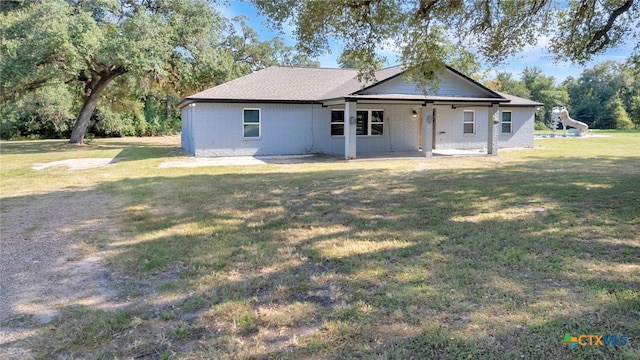 view of front facade with a front lawn and a patio