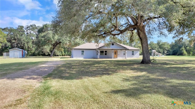 exterior space with a front lawn and a storage unit