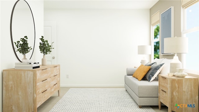 sitting room with baseboards and carpet floors