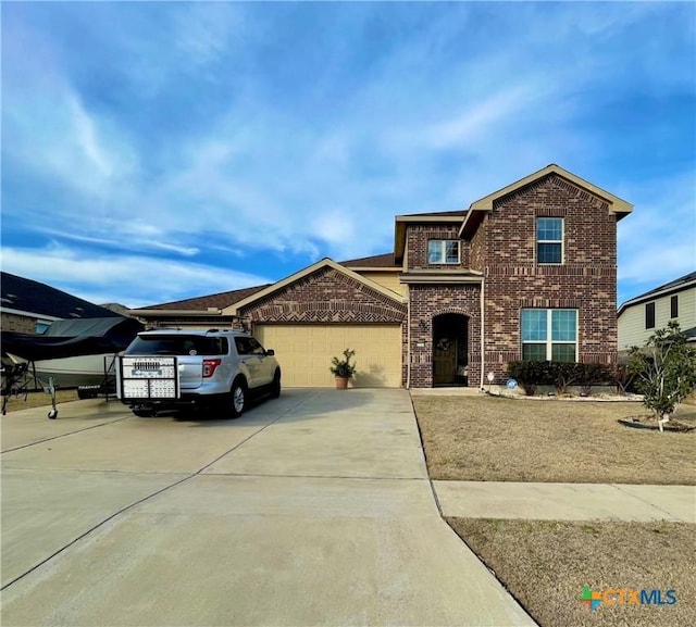 traditional home featuring brick siding, driveway, and an attached garage