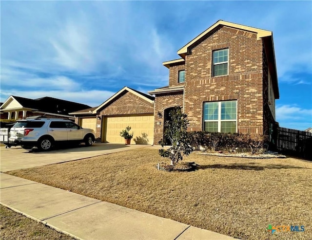 traditional home with driveway, a garage, fence, and brick siding