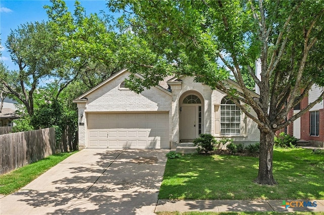 8430 Alvin High Ln, Austin, TX 78729 - view of front of house with driveway, brick siding, and a garage