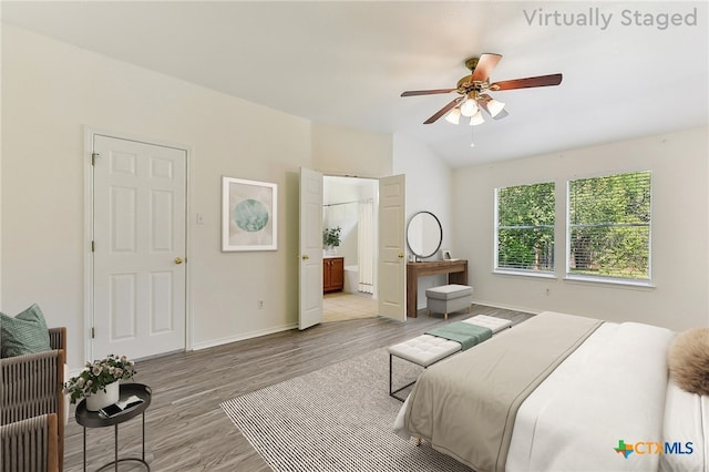 8430 Alvin High Ln, Austin, TX 78729 - bedroom with light wood-style flooring, lofted ceiling, baseboards, connected bathroom, and ceiling fan