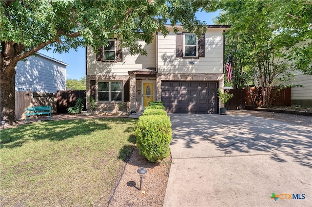 view of front of house featuring a front lawn and a garage