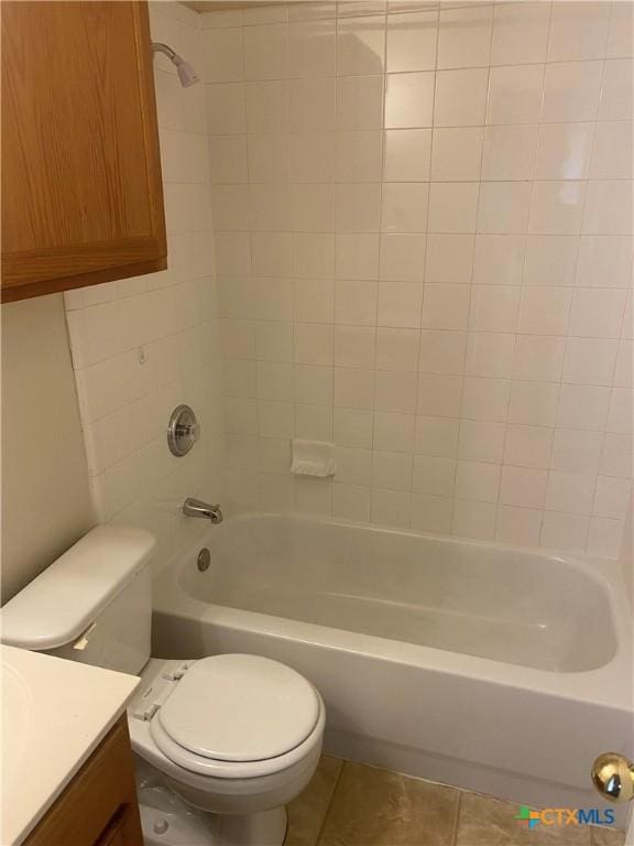 full bathroom featuring vanity, tile patterned floors, toilet, and tiled shower / bath