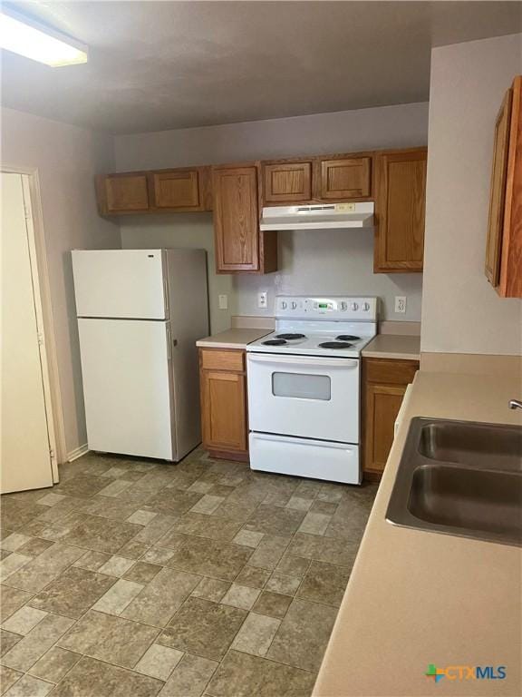 kitchen featuring sink and white appliances