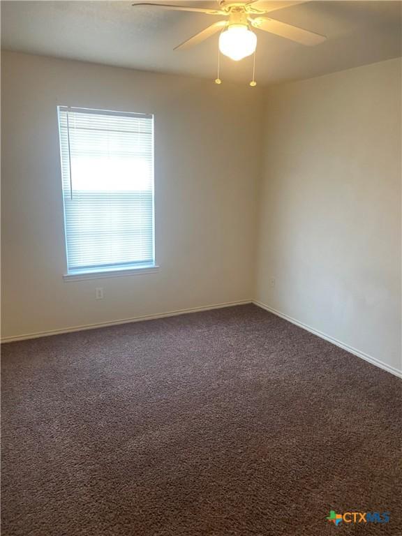 carpeted empty room with ceiling fan