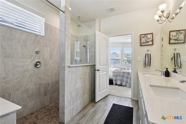 4032 Wild Bloom Rd, Seguin, TX 78155 - full bath featuring walk in shower, double vanity, plenty of natural light, and a chandelier