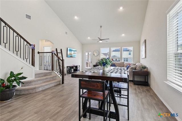 4032 Wild Bloom Rd, Seguin, TX 78155 - dining space featuring high vaulted ceiling, plenty of natural light, a ceiling fan, stairs, and arched walkways