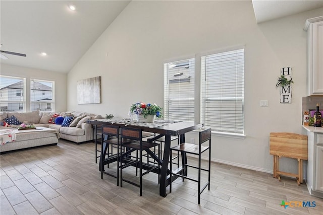 4032 Wild Bloom Rd, Seguin, TX 78155 - dining space with light wood finished floors, high vaulted ceiling, ceiling fan, and recessed lighting