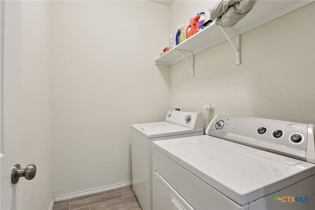 4032 Wild Bloom Rd, Seguin, TX 78155 - laundry room featuring washer and dryer and wood tiled floors