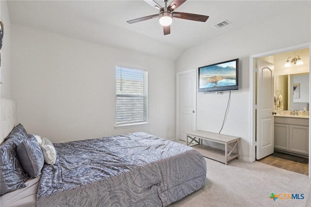 4032 Wild Bloom Rd, Seguin, TX 78155 - carpeted bedroom featuring vaulted ceiling, ensuite bath, wood finished floors, and ceiling fan
