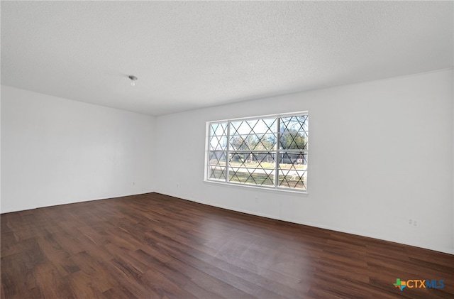 unfurnished room featuring hardwood / wood-style floors and a textured ceiling