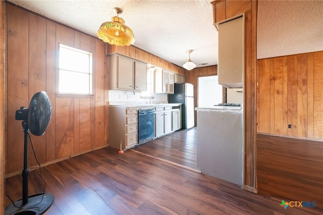 kitchen with a textured ceiling, stainless steel fridge, dark hardwood / wood-style floors, and black dishwasher