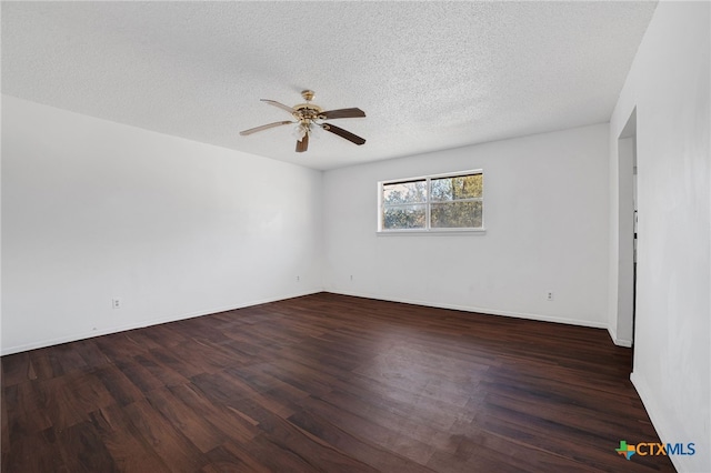 empty room with ceiling fan, dark wood-type flooring, and a textured ceiling