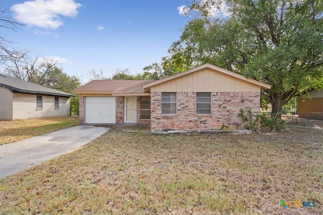 single story home with a garage and a front lawn