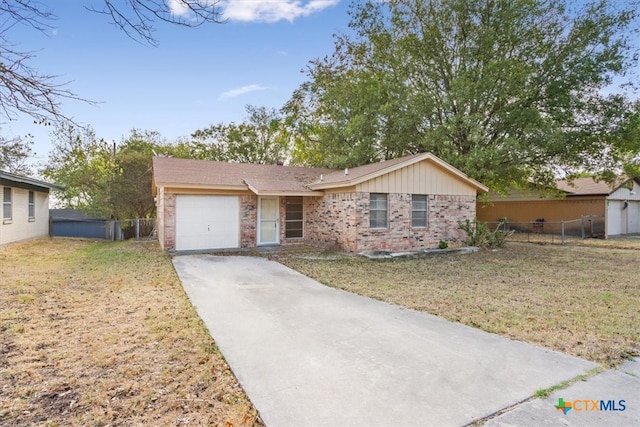 ranch-style home with a front yard and a garage