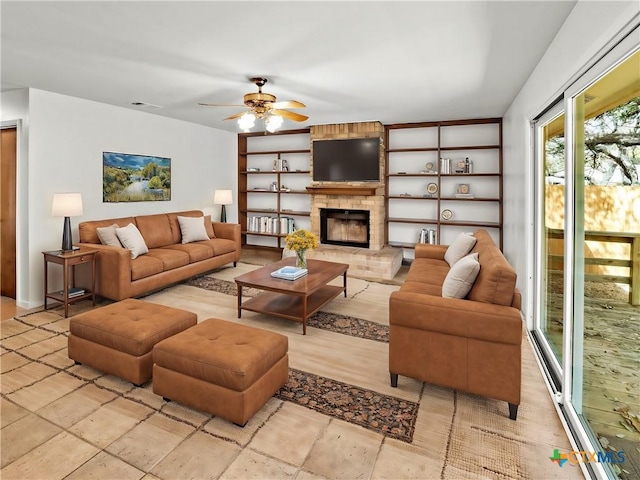 living room featuring visible vents, built in shelves, a brick fireplace, and ceiling fan