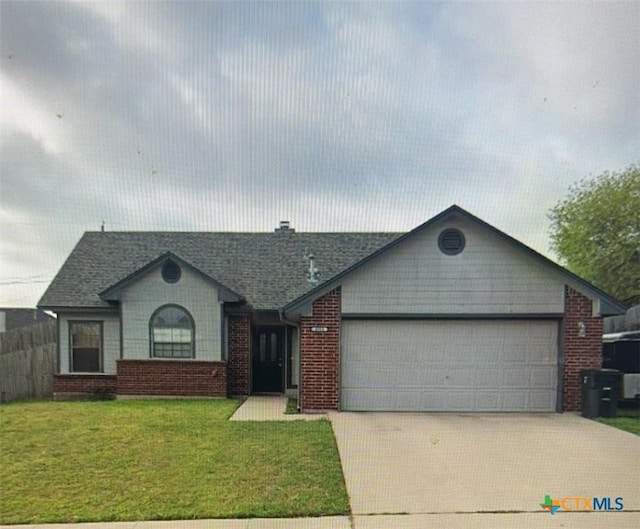 ranch-style house featuring a front yard and a garage