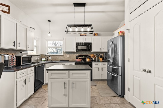 kitchen featuring dark countertops, white cabinets, a sink, and black appliances