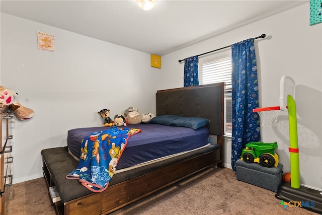 carpeted bedroom featuring baseboards