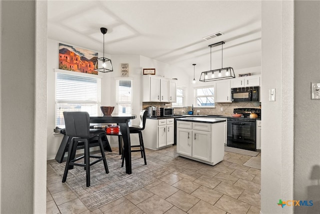 kitchen featuring dark countertops, visible vents, decorative backsplash, white cabinets, and black appliances