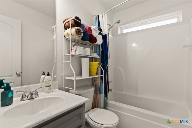 bathroom featuring vanity, toilet, and shower / tub combo with curtain