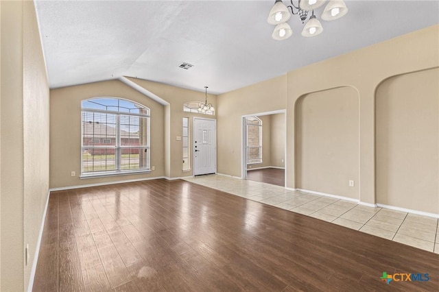 2003 Schottische Ln, Killeen, TX 76542 - unfurnished room featuring a chandelier, wood finished floors, vaulted ceiling, and baseboards