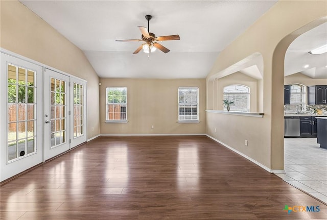 2003 Schottische Ln, Killeen, TX 76542 - unfurnished room with vaulted ceiling, ceiling fan, wood finished floors, arched walkways, and french doors